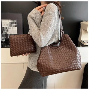 Close-up of dark brown woven tote bag with matching pouch in high-quality leather texture