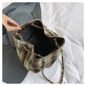 Top view of plaid wool bucket bag with chain strap showing interior pocket and magnetic closure