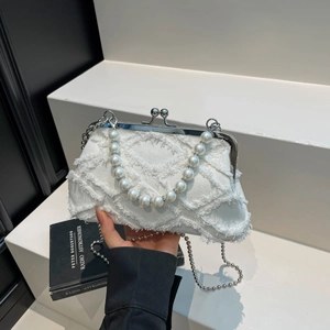 Vintage white denim shell bag with quilted texture, pearl handle and silver chain strap