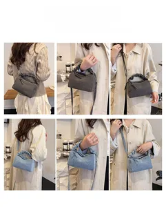 Detail view of ruched shoulder bags in grey and blue, showing crossbody and handbag styles