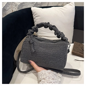 Minimalist grey textured canvas barrel bag with ruffled handle for casual shoulder use