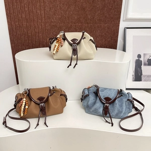 Chic denim and leather crossbody handbag set with drawstring and wooden bead charms