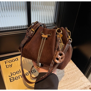 Close-up of retro brown frosted bucket bag featuring drawstring closure and gold hardware