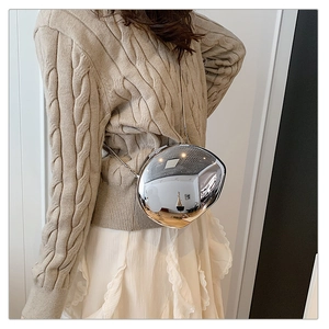Chic silver mirror irregular bag styled with metal chain and elegant casual outfit