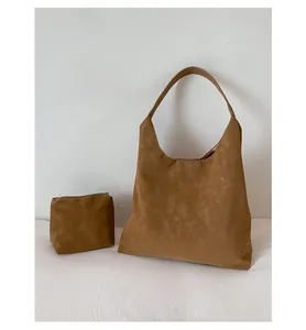 Detail of vintage matte suede tote bag with matching small zippered inner pouch