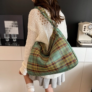 Fashionable green plaid drawstring tote bag with a unique knot shoulder strap design
