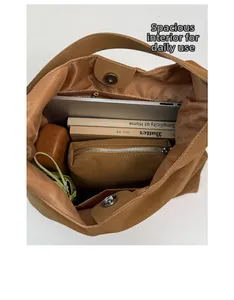 Interior view showing the large capacity of a brown tote bag with a zipper pocket