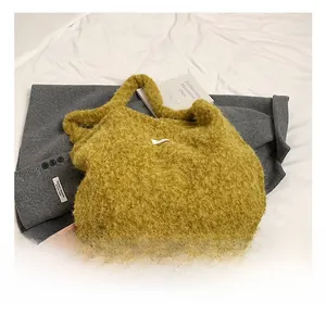 Macro shot of fluffy yellow wool tote bag with soft plush texture on grey suit fabric