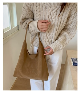 Brown suede hobo tote bag shown on shoulder for a stylish large capacity display
