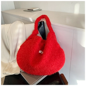 Detailed macro view of soft red faux fur texture on a vintage style hobo shoulder handbag