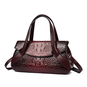 Vintage burgundy crocodile pattern handbag with top handle and shoulder strap