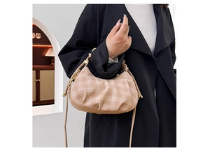 Detail view of coffee-colored checkered cloud bag with pleated design and thin shoulder strap