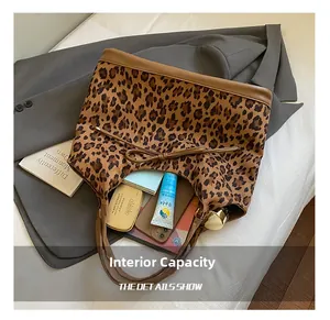 Internal capacity of leopard print tote bag with phone and cosmetics inside