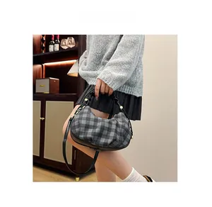 Fashionable checkered cloud bag with crescent pleats shown on a model for daily use
