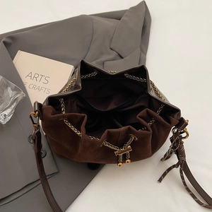 Close-up of brown bucket bag interior showing spacious lining and secure zipper pocket