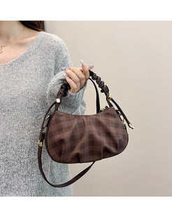 Detail of checkered hobo bag showing pleated handle and gold cylindrical hardware