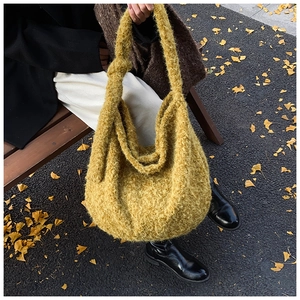 Detail of yellow wool knit hobo bag with curly plush texture in autumn outdoor scene