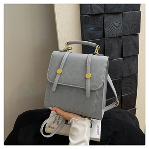 Détail du sac à dos gris motif léopard avec boucles dorées et poignée supérieure chic
