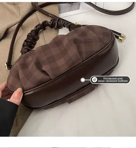 Detailed view of the thickened wear-resistant base on the coffee plaid cloud tote bag