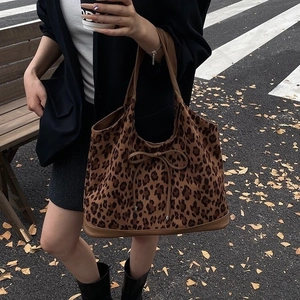 Leopard print tote bag with bow detail and leather handles in a street fashion style