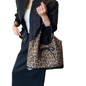 Leopard print tote bag with black bow detail and reinforced leather base for women