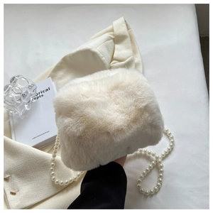 Detail of white faux fur shoulder bag with elegant pearl chain strap and soft plush texture