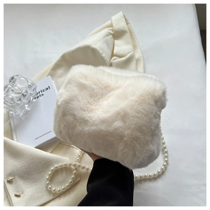 Detail of soft faux fur handbag with elegant large pearl strap on a stylish background