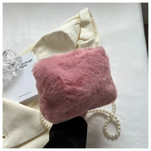 Detailed view of pink plush bag with faux fur texture and elegant pearl shoulder strap