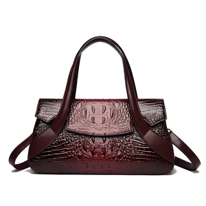 Deep red crocodile texture handbag with dual handles and crossbody strap for women
