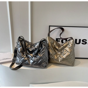 Vue détaillée de sacs fourre-tout matelassés métallisés argent et or sur un présentoir