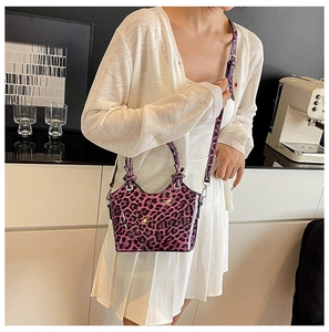 Detailed view of glossy leopard print mini tote bag with adjustable shoulder strap