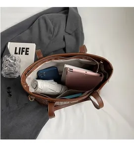 Interior view showing the large storage capacity of the brown leather woven tote bag