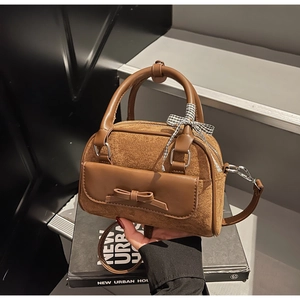 Brown suede shoulder bag with bow flap pocket and checkered ribbon handle detail