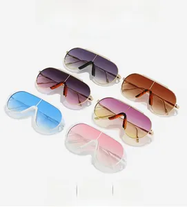 Flat lay of oversized pilot sunglasses in various gradient colors with metallic frames