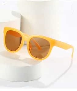 Detail view of oversized bright yellow candy color sunglasses on a white pedestal