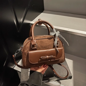 Brown Boston handbag with suede patchwork, bow detail and checkered ribbon on album