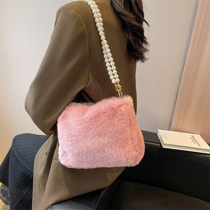 Pink faux fur handbag with elegant pearl strap shoulder bag for women shown on model