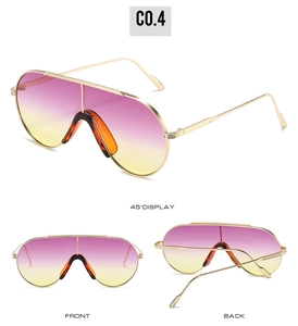 Detail view of oversized shield sunglasses with pink-yellow gradient lenses and gold frame