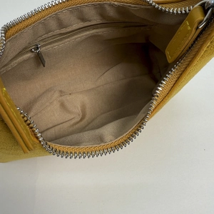Close-up of crescent bag interior showing zipper pocket and smooth fabric lining