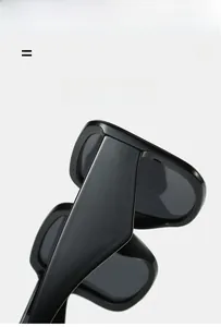 Detail view of black square sunglasses showing the lightweight and super elastic frame