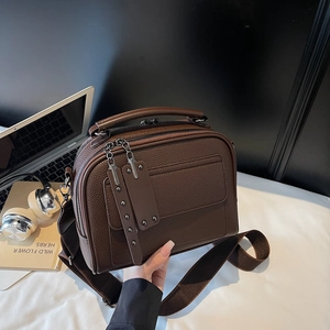 Deep brown pebble leather crossbody bag with wide strap for minimalist urban commuting style