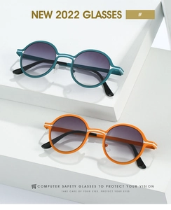 Detail of retro round glasses in green and orange with gradient lenses on white props