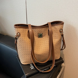Retro beige woven tote bag with brown leather trim and metal hardware details