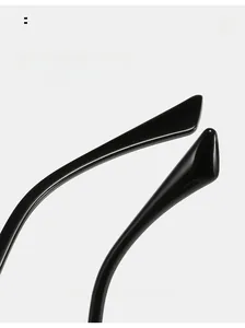 Macro view of curved ergonomic temple tips on black square frame sunglasses for comfort