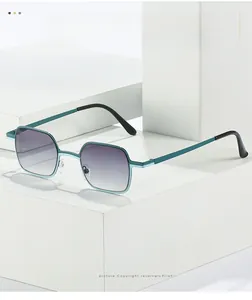Detail of square teal metal sunglasses with purple gradient lenses on geometric props