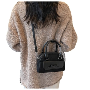 Black vintage shoulder bag with bow detail and plaid ribbon shown on model back