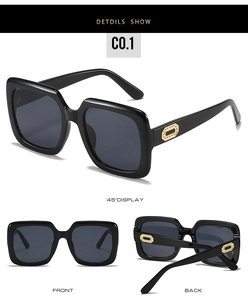 Gros plan de lunettes de soleil carrées noires avec verres gris et détails dorés