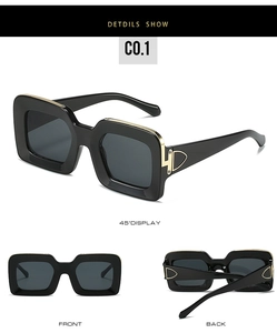 Detail view of large square leopard print sunglasses with gold temple accents in black