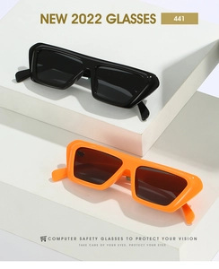 Detail view of bold square sunglasses in classic black and vibrant orange color frames