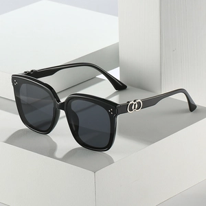 Classic square oversized black sunglasses with metal interlocking ring detail on white block